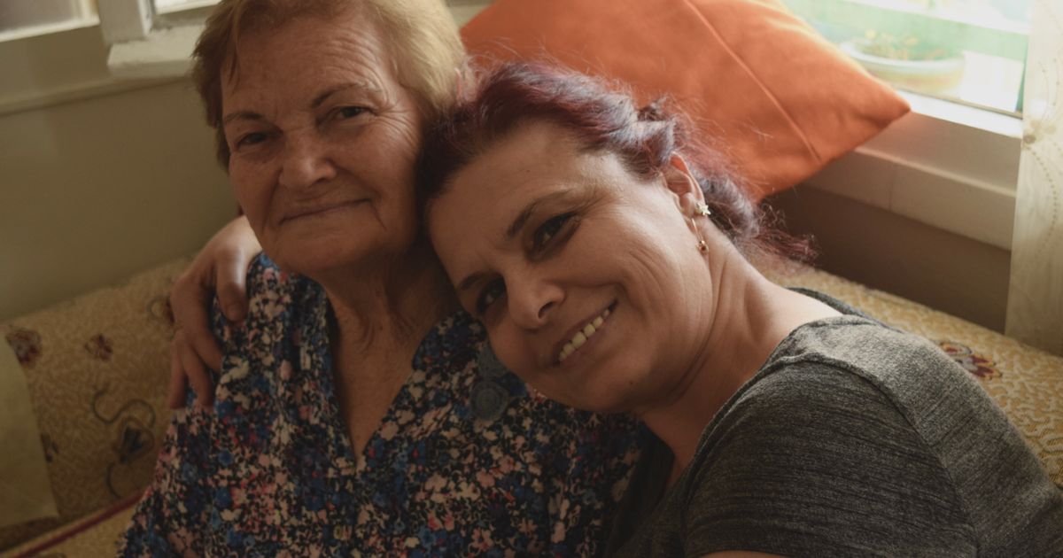 Two women sharing a warm moment at home