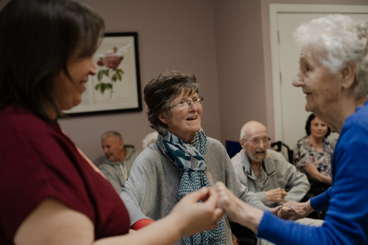Older adults laughing together at a small group gathering